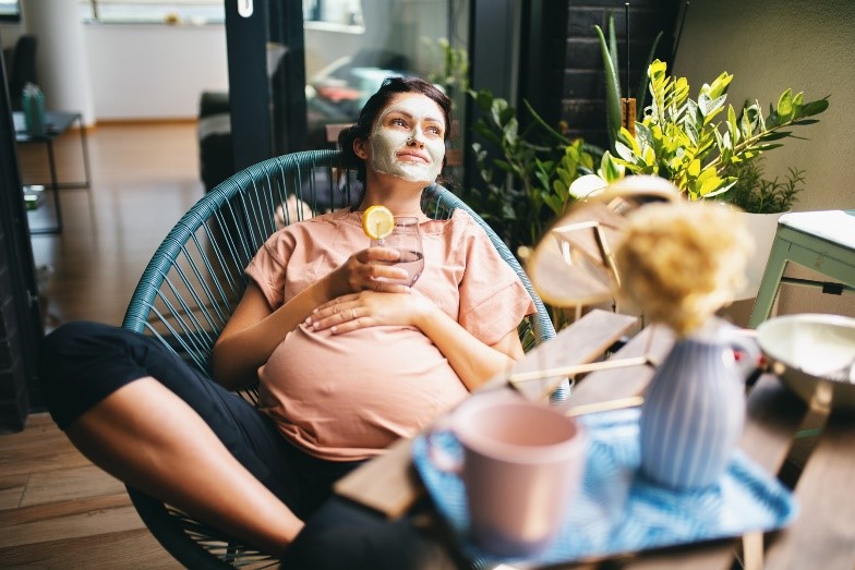 A person sitting in a chair with a drink