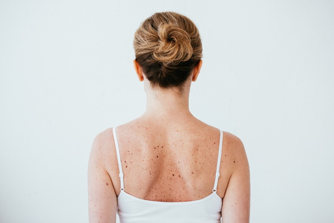 A person with her hair tied back