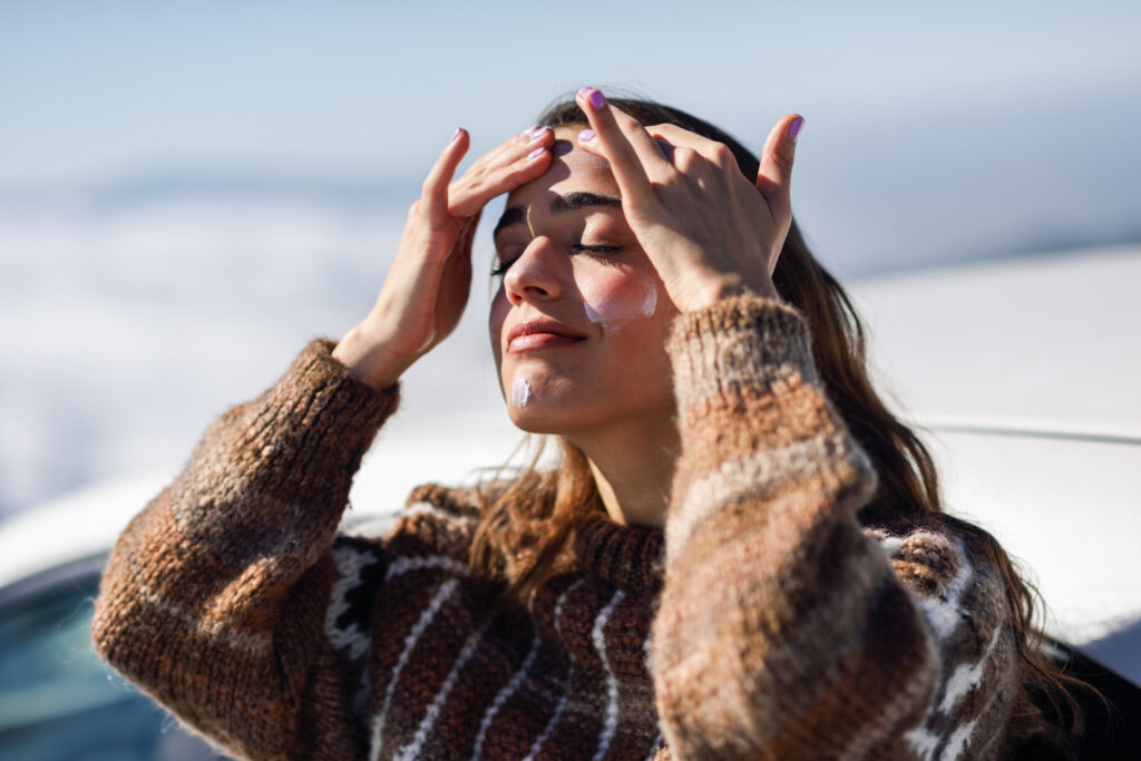 A person with her hands on her forehead.